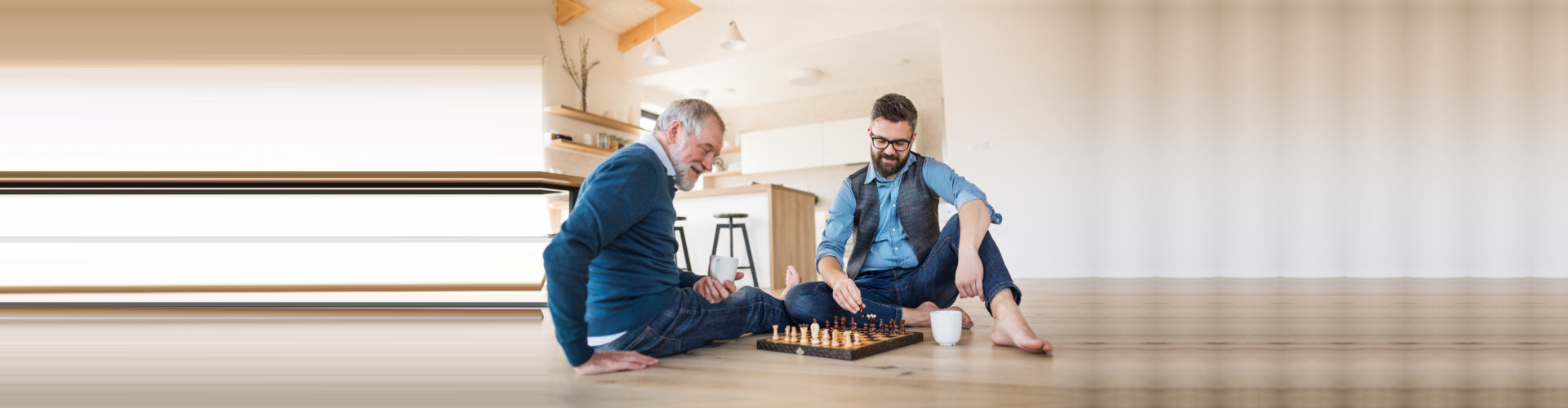 caregiver with elder man playing chess