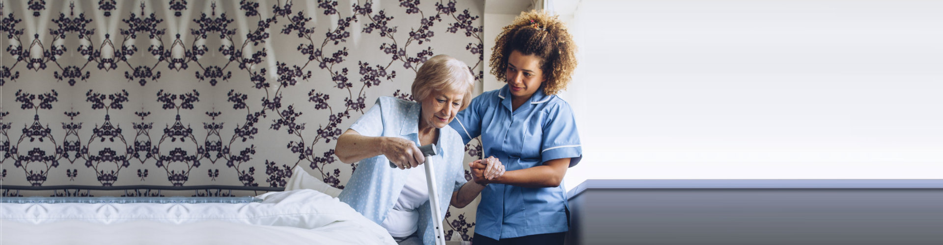 caregiver assisting elder woman in standing up concept