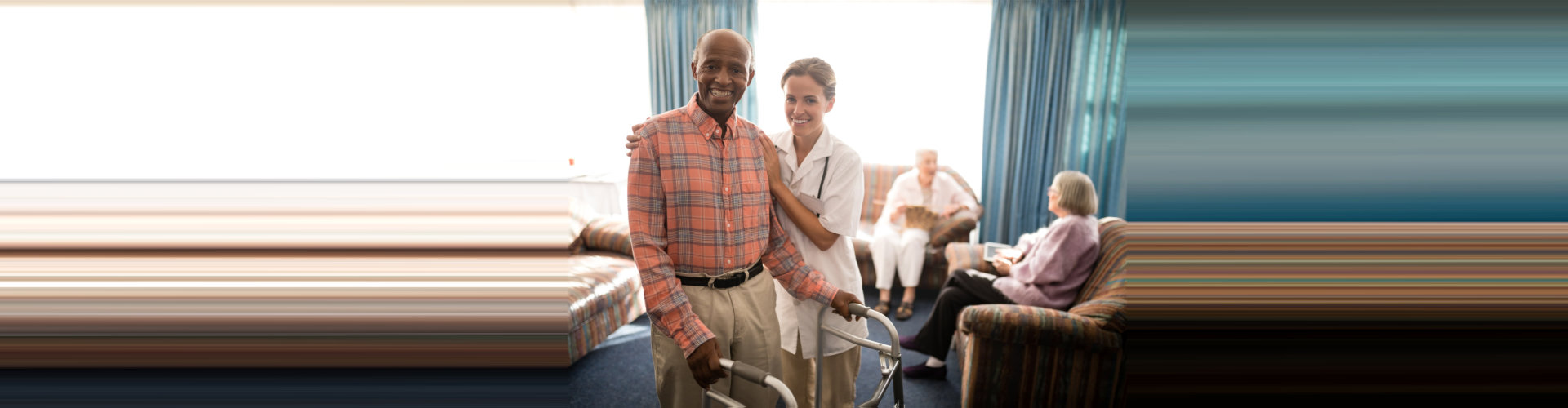 caregiver assiting elder man using a walker